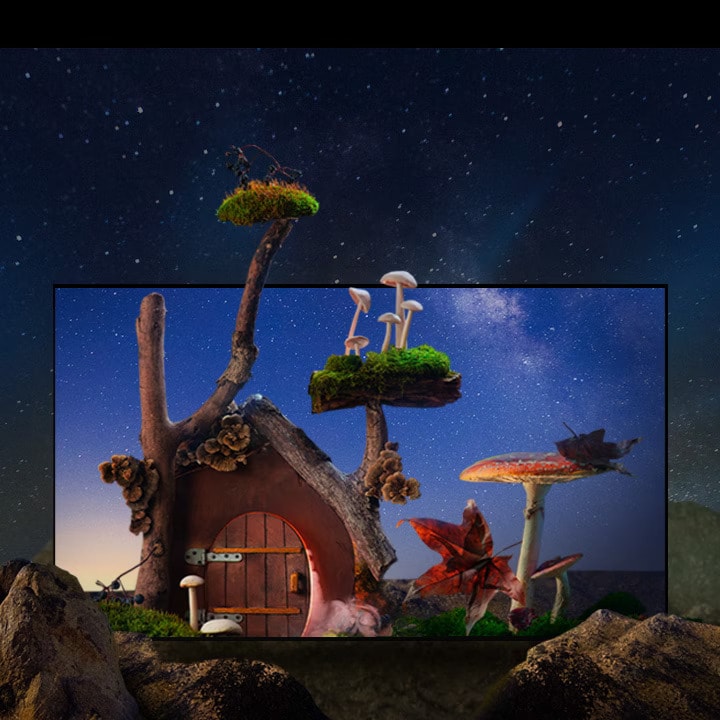 Une petite maison fantastique avec des arbres, des champignons et de gros rochers se trouve sous un ciel étoilé