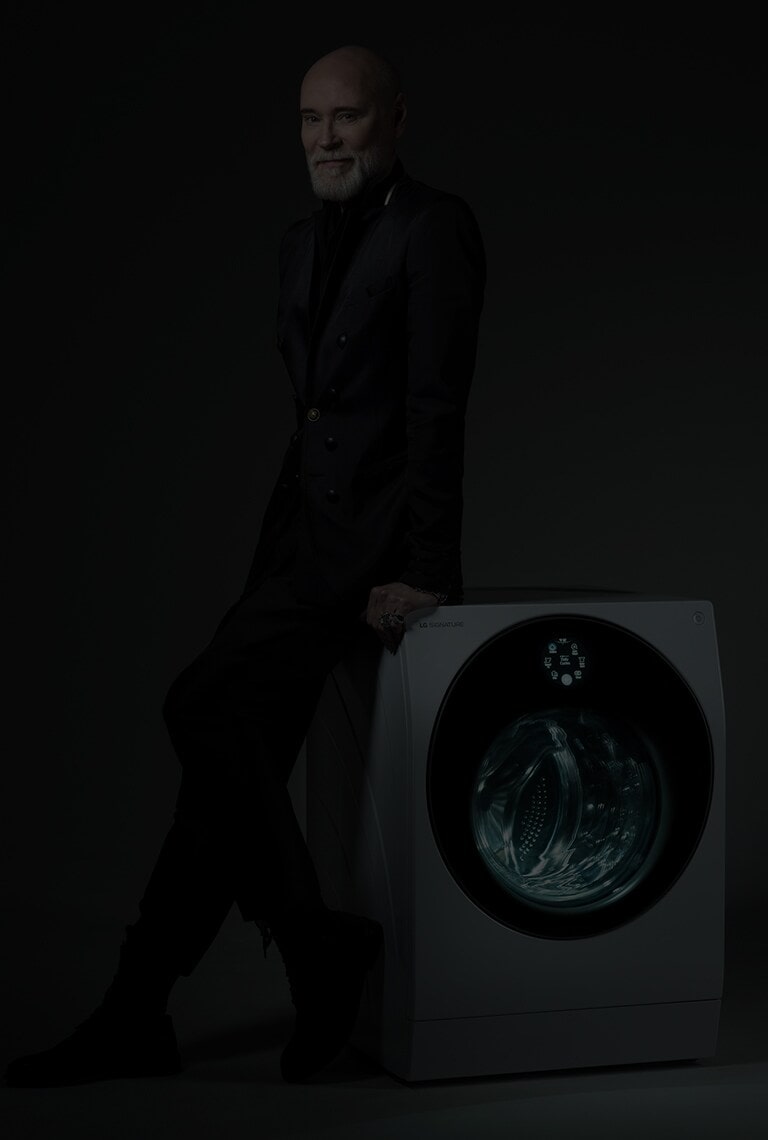 Modeskaparen Lars Wallin lutad mot en LG SIGNATURE tvättmaskin