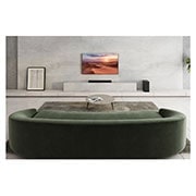 LG Barre de son 3.1.2 | 380W | Dolby Atmos | DTS:X | eARC | Hi-Res Audio, Une barre de son est placée sous un téléviseur dans un salon blanc, un haut-parleur arrière est placé juste à sa droite, S75Q, thumbnail 13