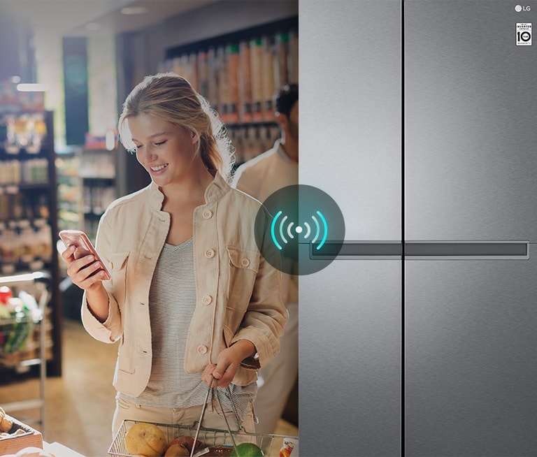 Image on the left shows a woman standing in a grocery store looking at her phone. Image on the right shows the refrigerator front view. In the center of the images is an icon to show connectivity between the phone and refrigerator.