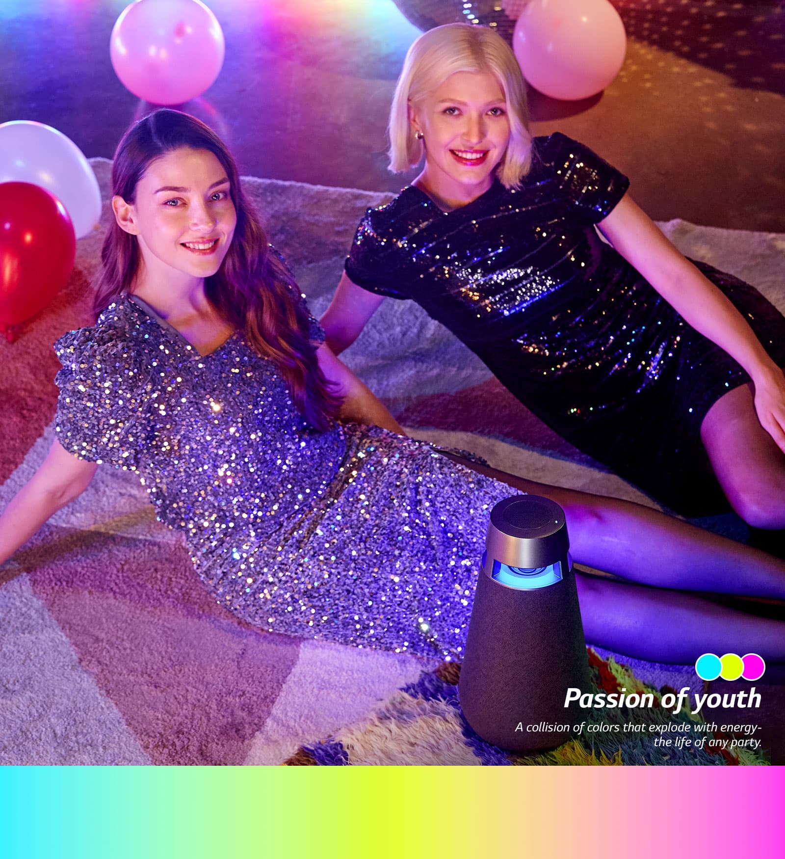 Two women sitting on the floor and smiling in the party with the Party mode of XO3.