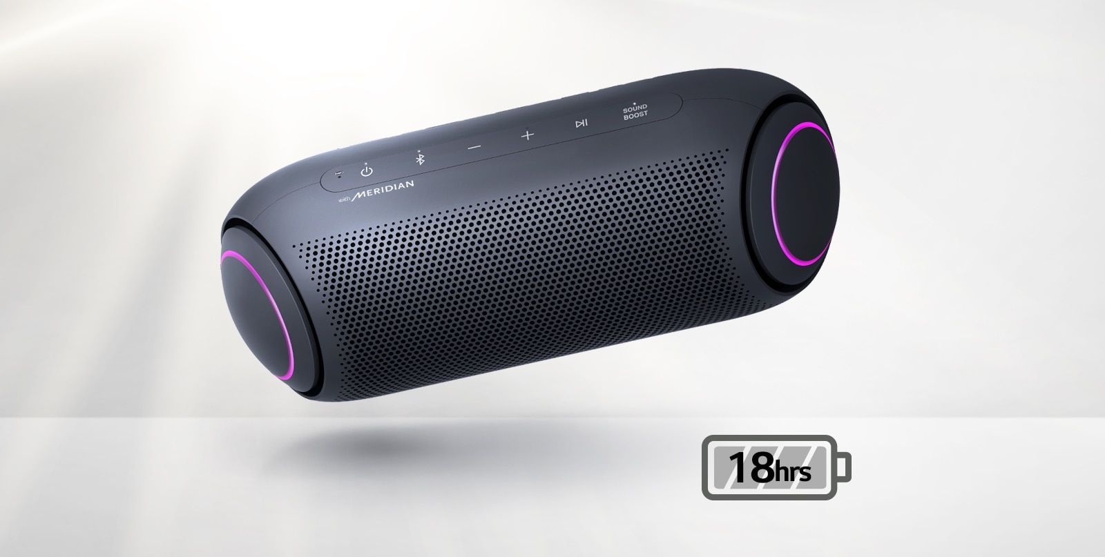 LG XBOOM Go tilts to the left and floats in the air. The woofer lighting is magenta. 