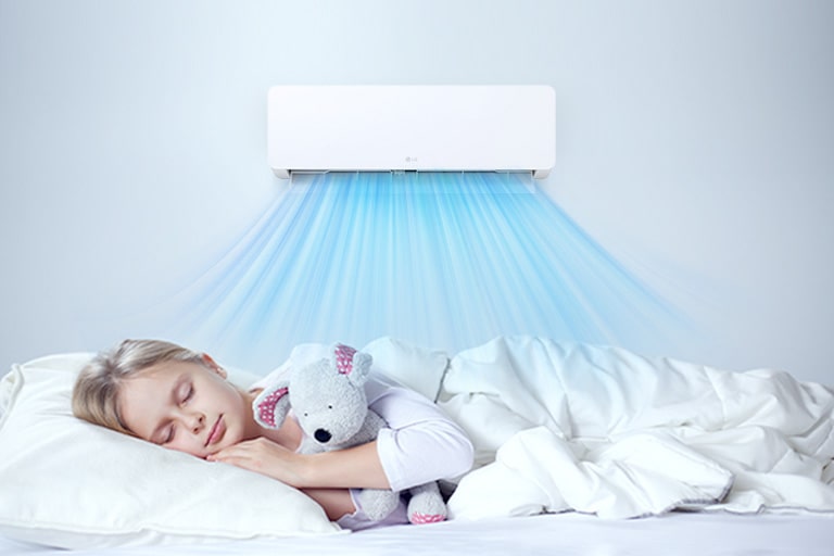 The air conditioner is operating. Below it, a girl is sleeping comfortably holding a doll.