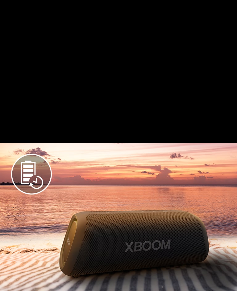 The speaker is placed on a beach towel. In front of the speaker, it shows sunset beach to illustrate that this speaker can be played up to 24 hours.