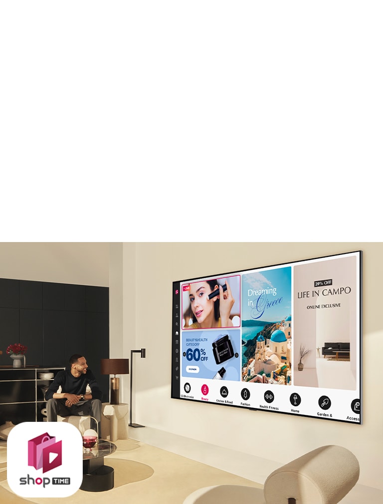 A couple looks at the home shopping channels on a large wall-mounted LG TV in a modern living space.