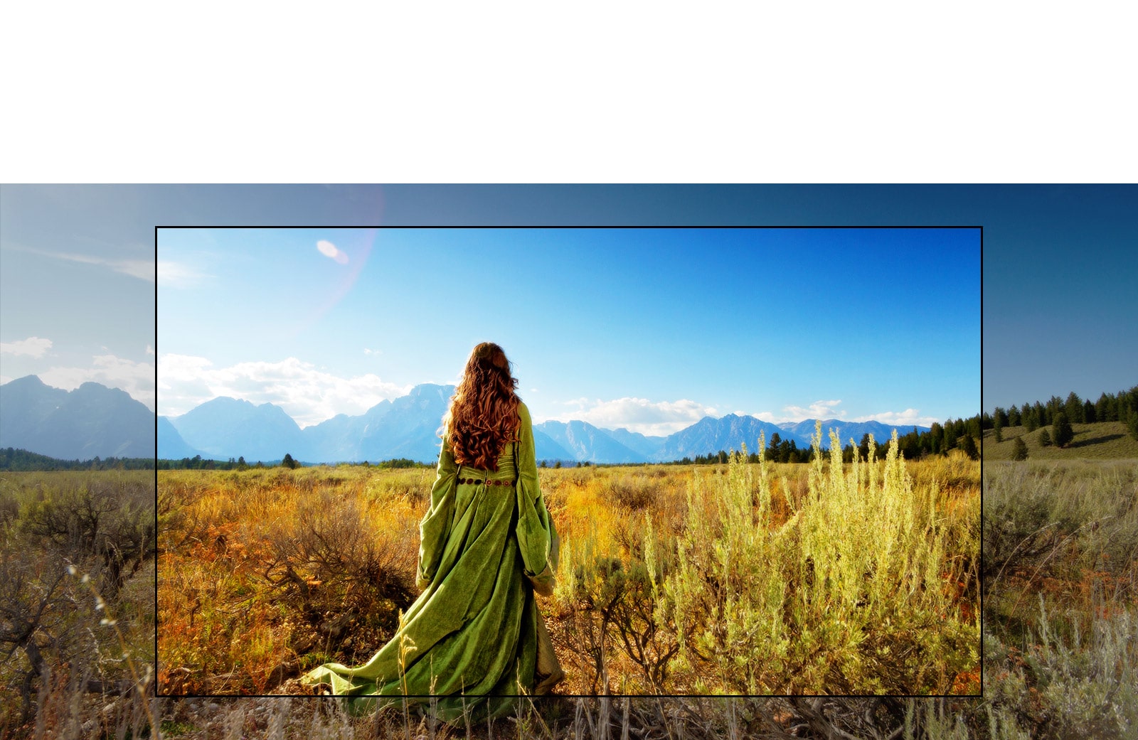 شاشة تلفزيون تعرض مشهدًا من فيلم خيالي مع امرأة تقف في الحقول المواجهة للجبال.