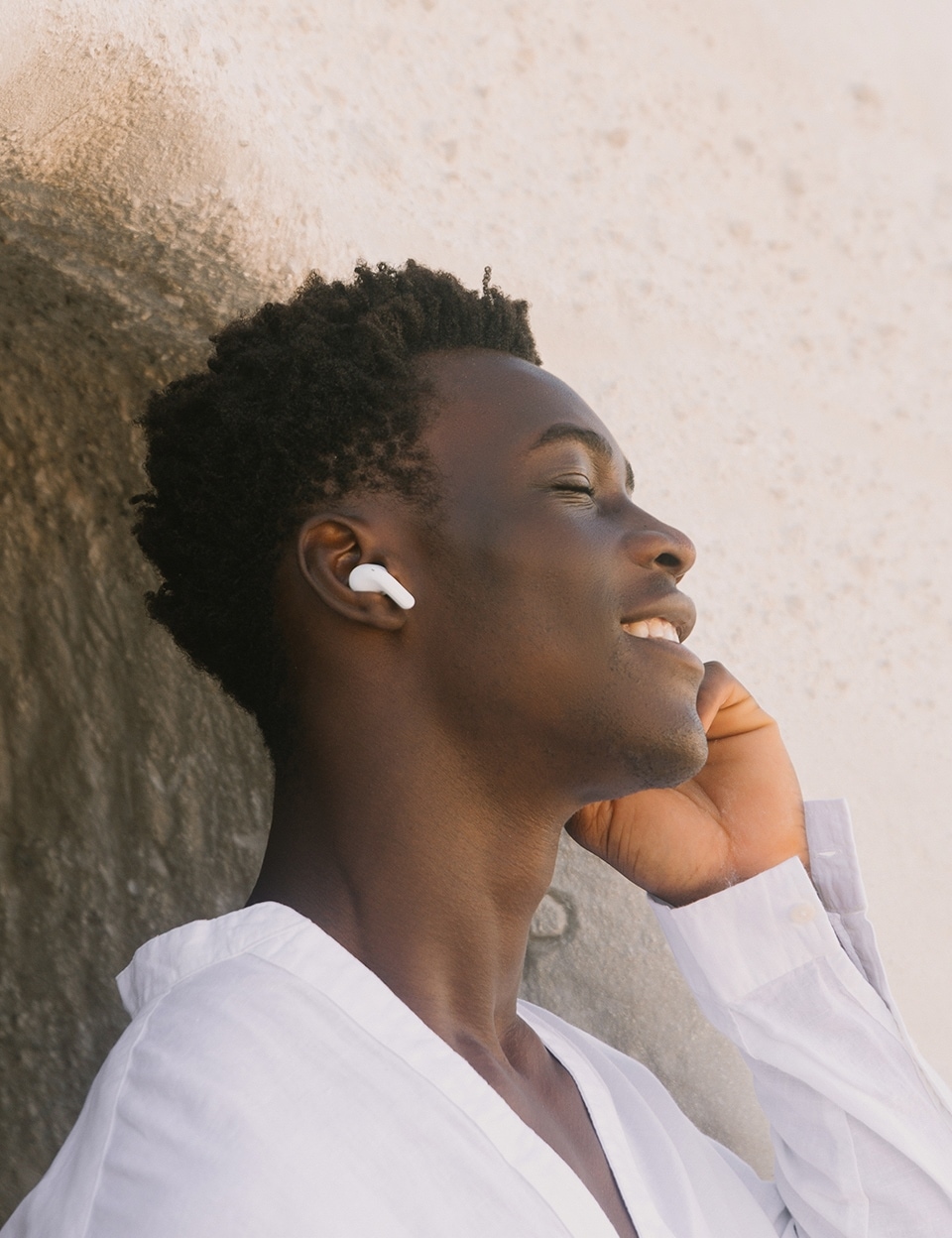 man wearing LG TONE Free UT90Q earbuds