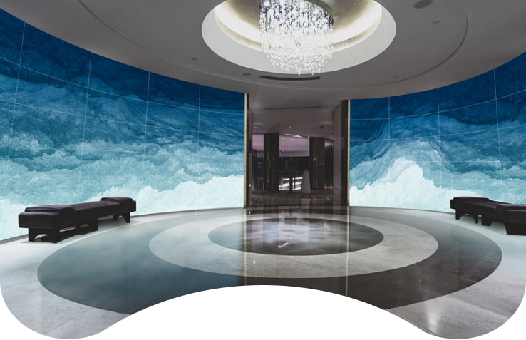 A Flexible Curved Open Frame OLED Signage fills the cruise lobby at a magnificent scale. 