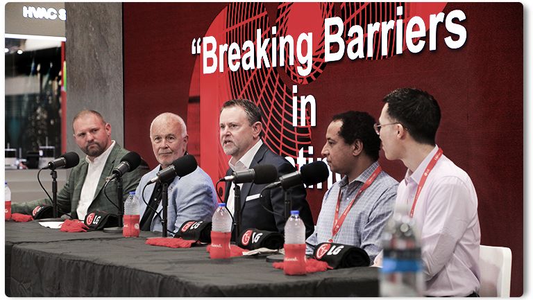 Breaking Barriers panel at a conference discussing business and technology, featuring industry professionals.