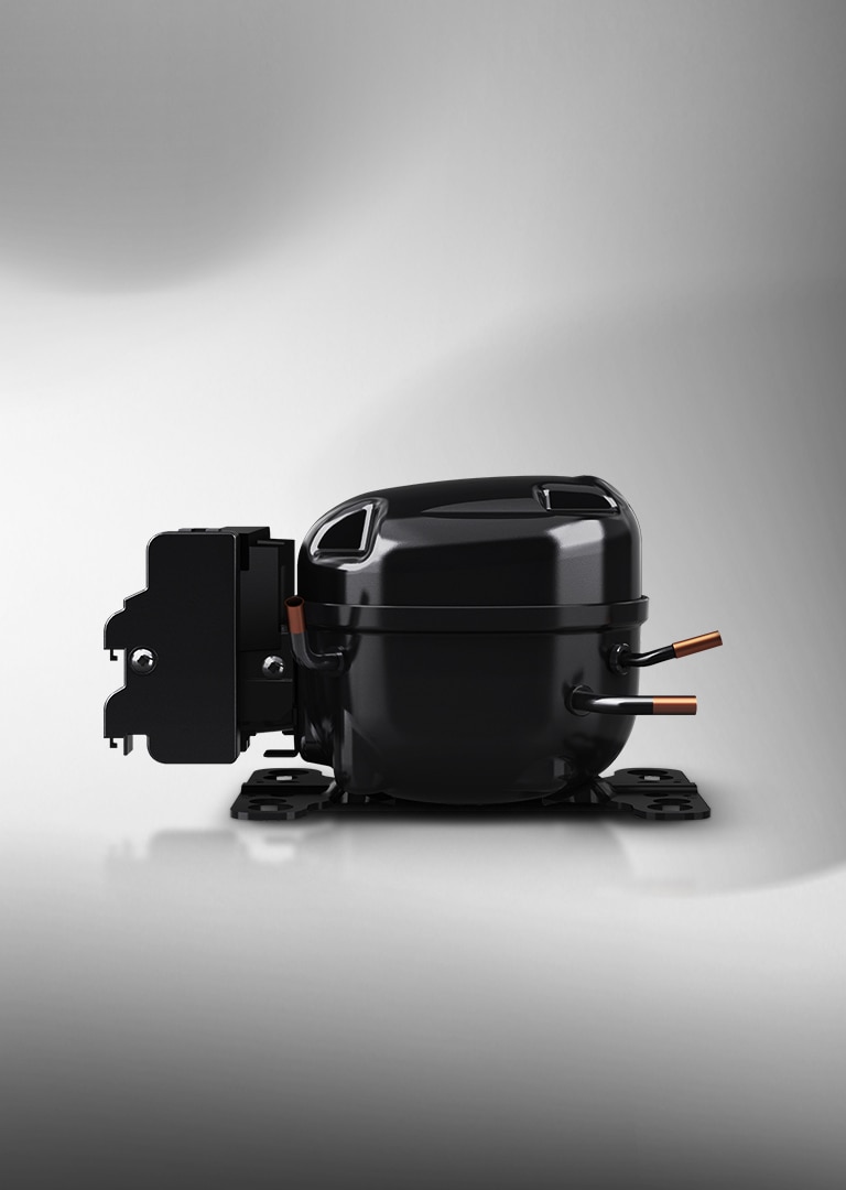 LG's variable speed reciprocating compressor in black with metallic accents is highlighted under lighting.