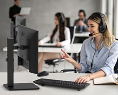 A woman with a headset talking to customer in call center.	