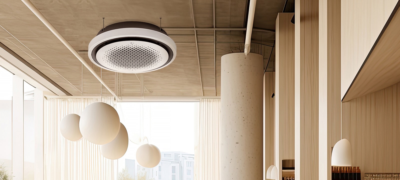 The LG Round Cassette is centrally installed in a sunlit room with high ceilings, blending modern design with the room's elegant wood accents and large hanging light fixtures. 