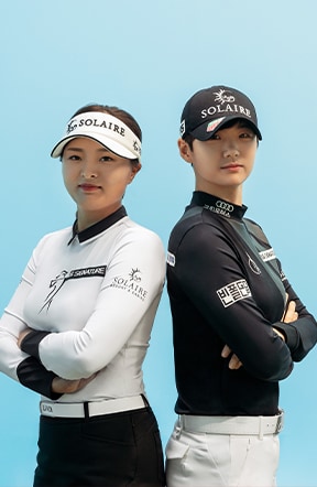 Jin Young Ko and Sung Hyun Park stood back to back against a blue backdrop.