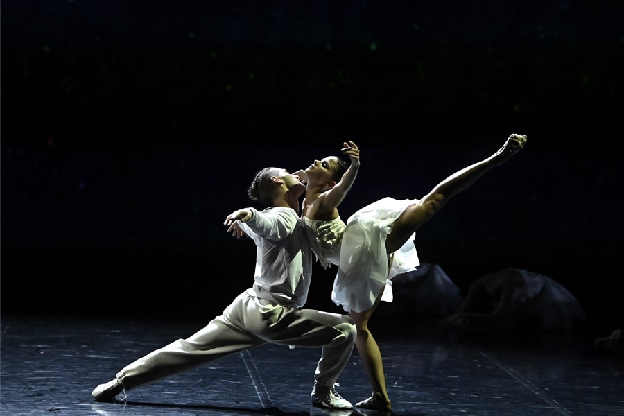 A photo of a male and female dancer in the middle of a pose on stage.