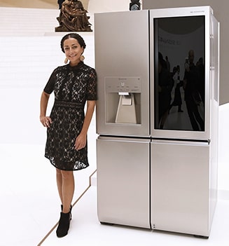 an woman is standing in front of lg signature refrigerator at lanching event in mexico