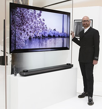 a man is standing in front of lg signature oled tv at lanching event in mexico