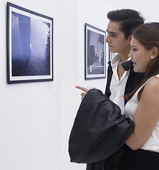 two people are standing in front of lg signature commercial photographs at lanching event in mexico