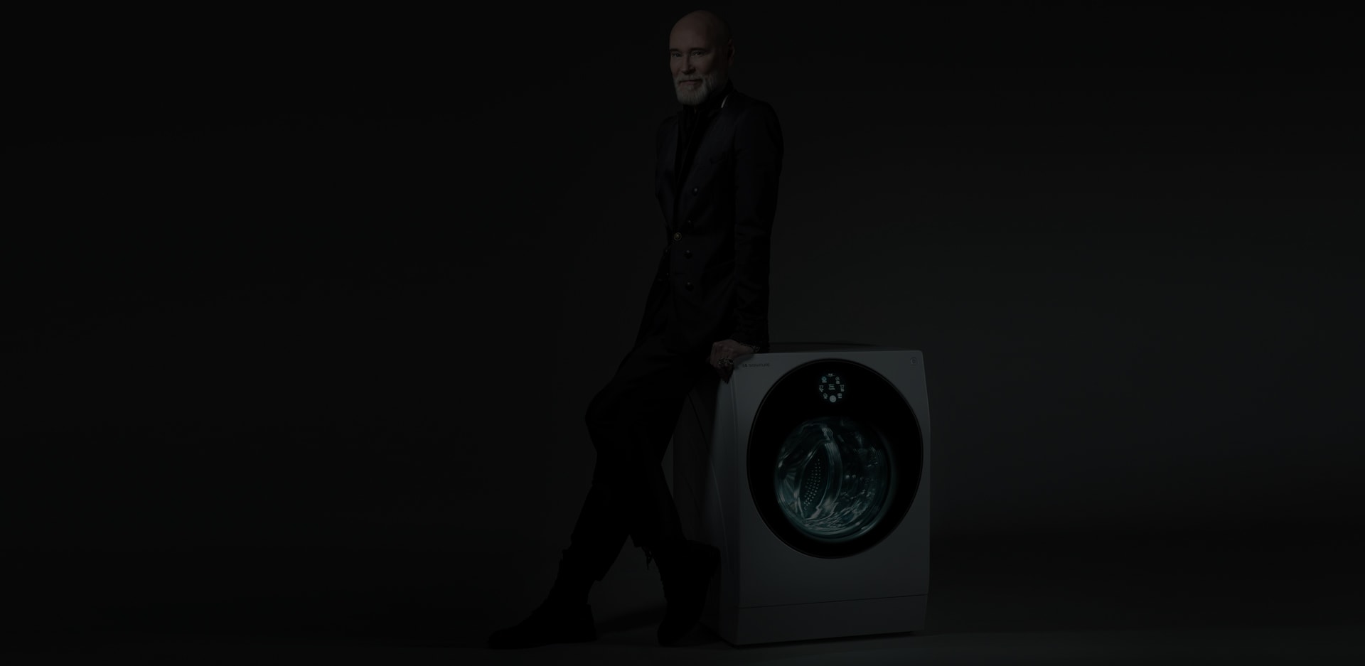 Fashion designer Lars Wallin leaning on a LG SIGNATURE Washing Machine