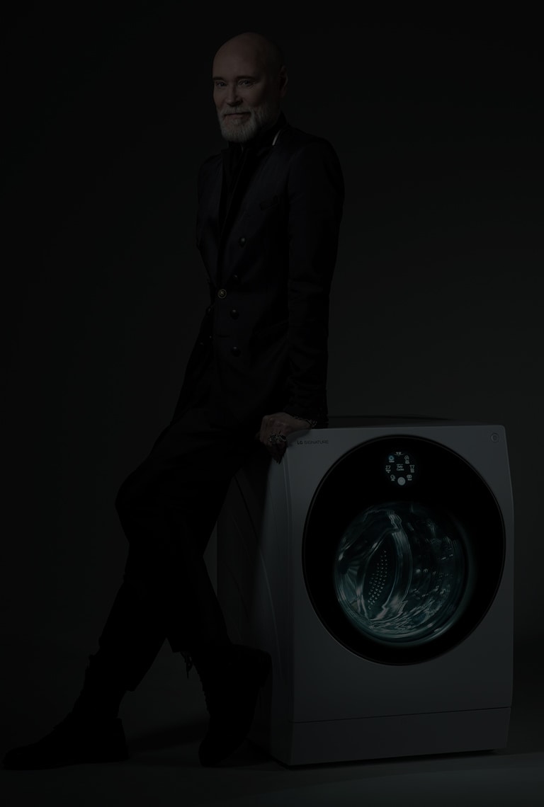 Fashion designer Lars Wallin leaning on a LG SIGNATURE Washing Machine