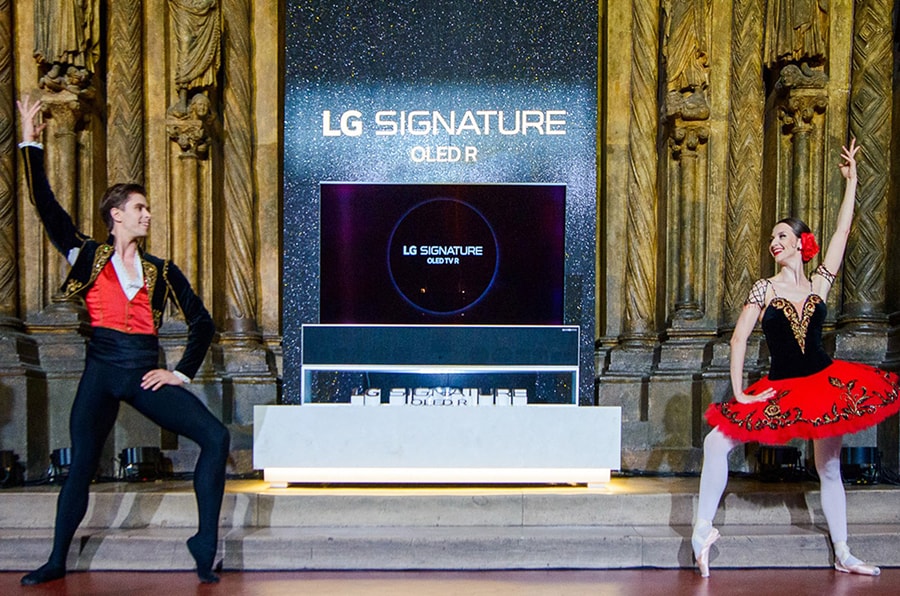 A photo taken during the launch of LG OLED R at the Pushkin Museum with two ballet dancers performing in front of the groundbreaking TV