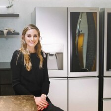 Olivia Palermo sat in front of an LG SIGNATURE Refrigerator.