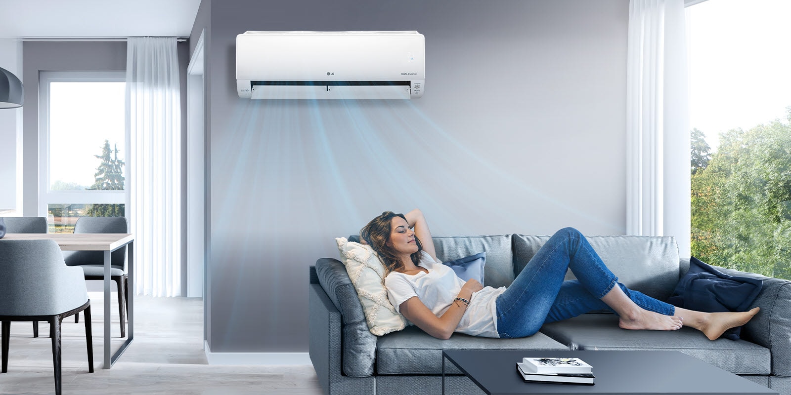 A woman relaxes on a sofa in a living room with the LG air conditioner mounted on the wall above her. The image shows blue air jets indicating that the air conditioner is on and cooling the room.