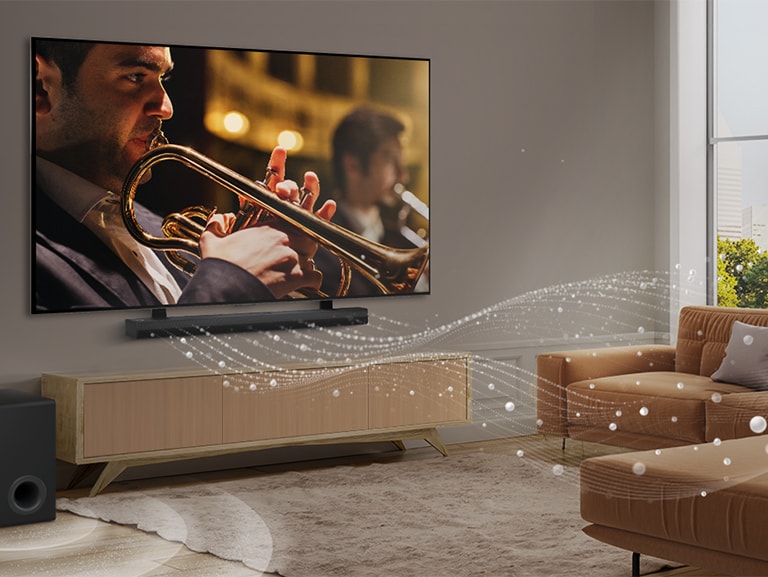  LG Soundbar, LG TV i niskofrekventni zvučnik (subwoofer) u modernom gradskom stanu. LG Soundbar emitira tri zvučna vala, sačinjena od bijelih kapljica koje lebde duž dna poda. Pored Soundbar-a je niskofrekventni zvučnik (subwoofer) koji stvara zvučni efekt odozdo. 