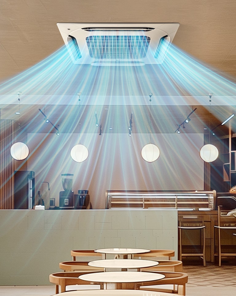 The LG ceiling-mounted cassette disperses cool air in multiple directions, evenly cooling the space. The setting appears to be a modern café or restaurant, with indoor plants and warm lighting.