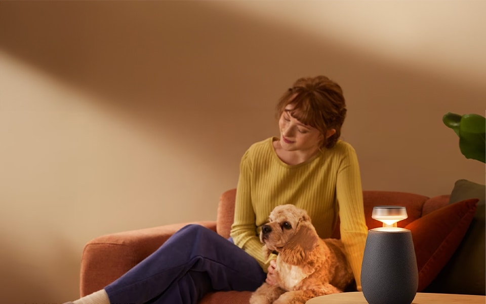 woman and dog enjoying the sound of LG XBOOM 360 portable, bluetooth, wireless speakers with surround sound system