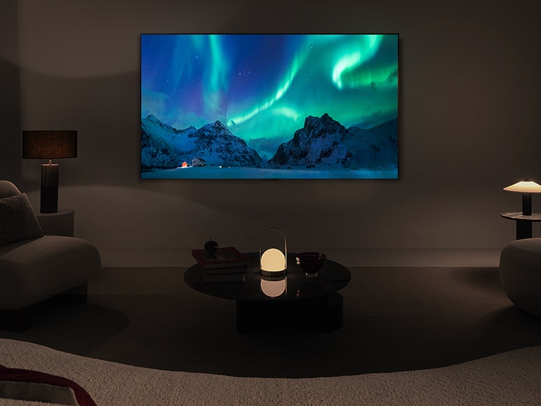 An image of an LG OLED TV and LG Soundbar in a modern living space in nighttime. The image of the aurora borealis is displayed with the ideal brightness levels.