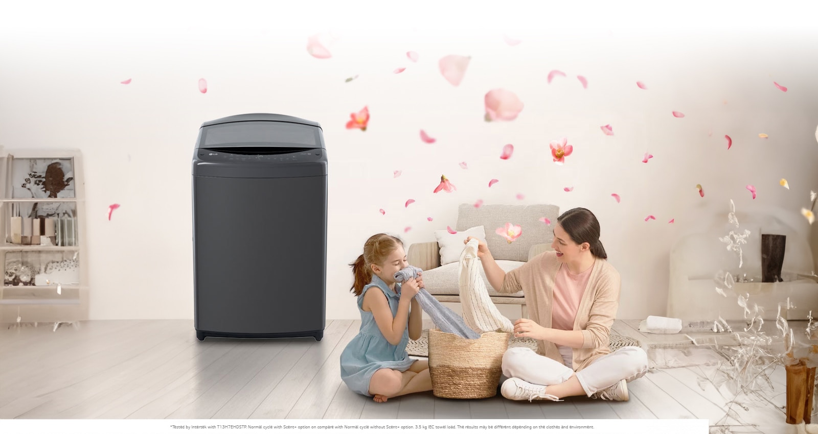 The 'scent' button on the LG washing machine is emphasized, a mother and daughter sit on the floor enjoying the smell of a towel that just came out of the washing machine that sits next to them. Petals are flying around them.