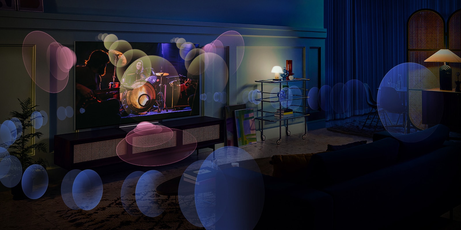 An image of an LG OLED TV in a blue, dimly lit room showing a music concert. Bubbles depicting virtual surround sound fill the space.