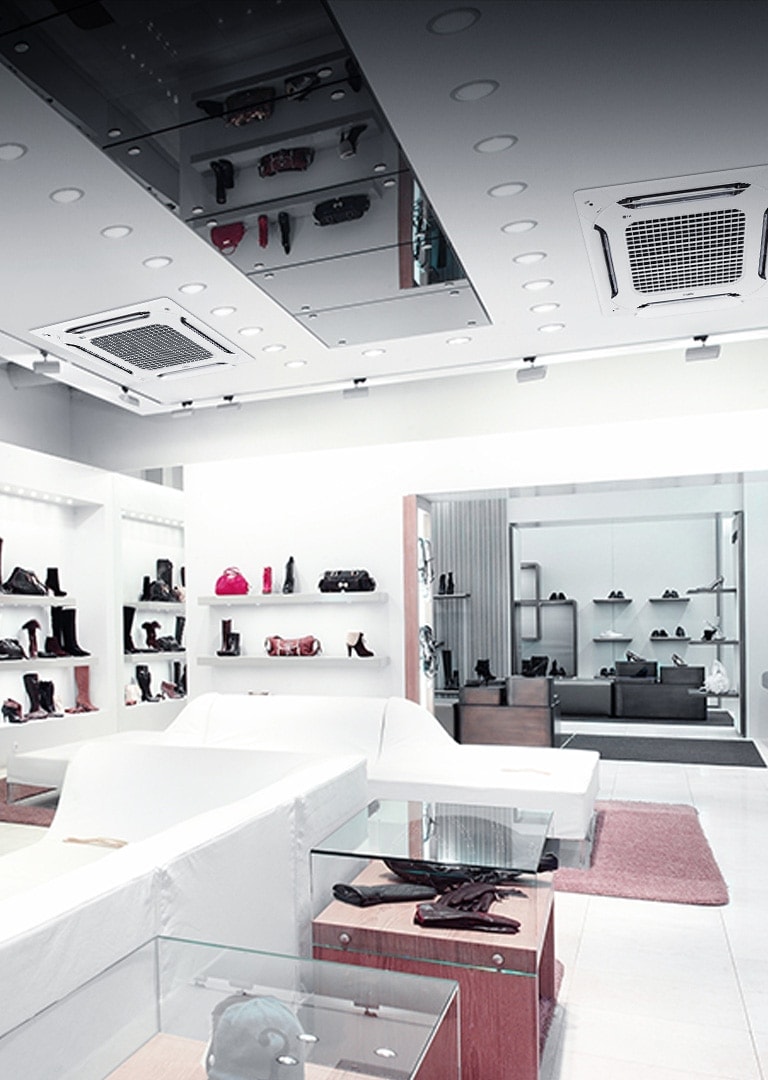 Two LG Multi V indoor units are installed in a modern, upscale retail store for air conditioning, ensuring a comfortable shopping environment. The retail store features white walls and sleek shelving displaying various handbags and shoes.