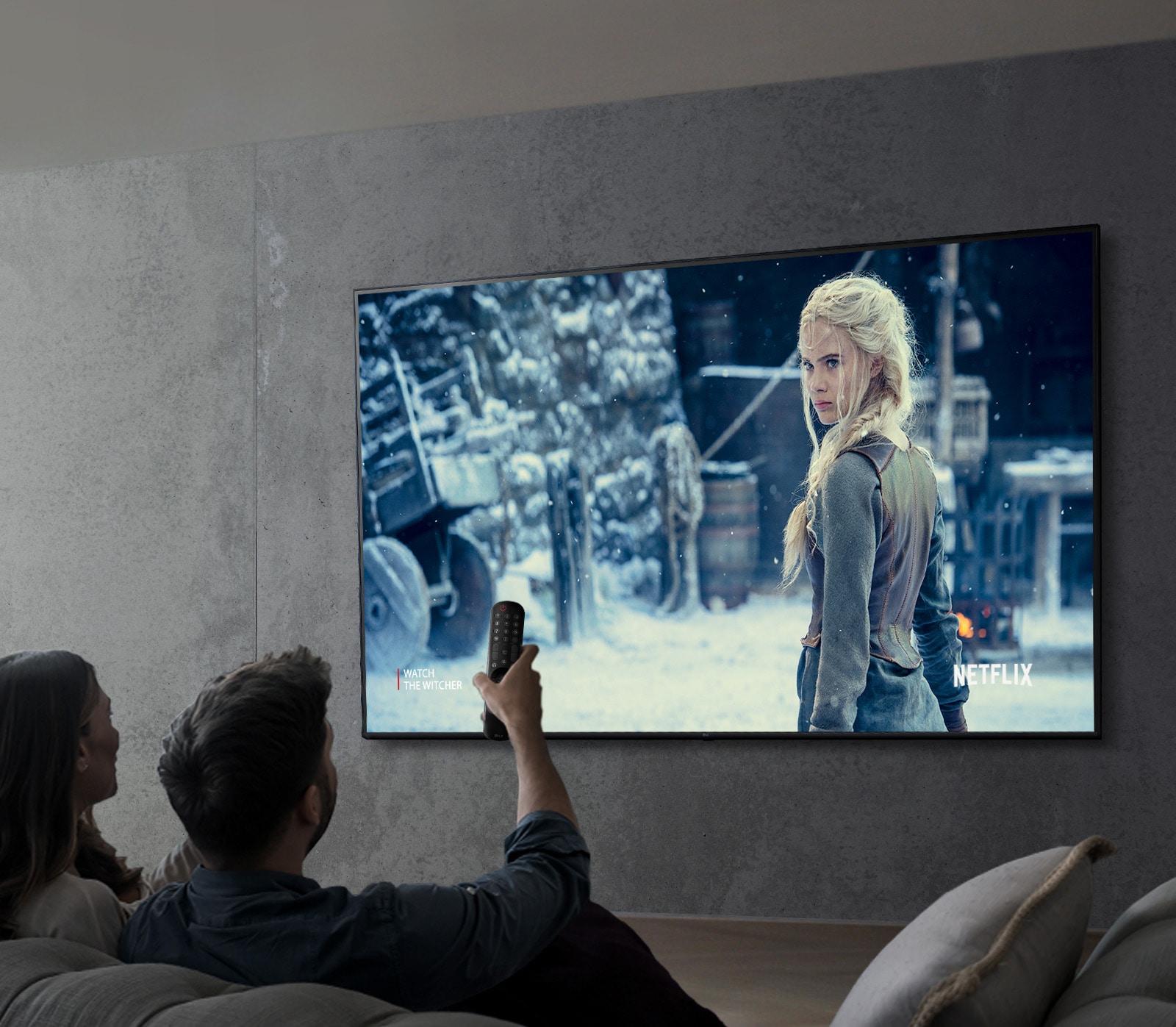 An image of a couple watching a show on an LG UHD TV.