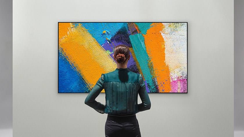 Woman enjoying an abstract artwork on a Gallery Design TV