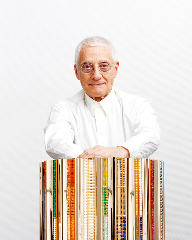 Alessandro Mendini was looking straight ahead with hist artistic sculpture.