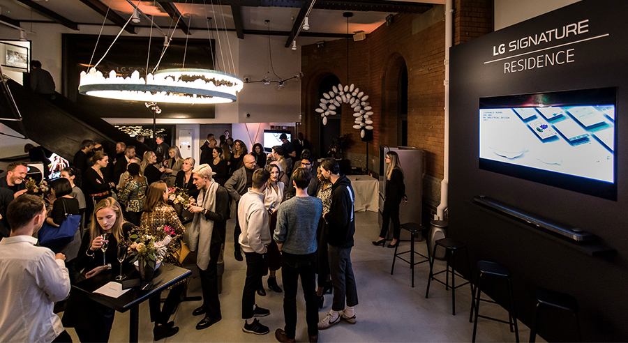 Audiences are standing and having conversation each other right in front of LG SIGNATURE OLED TV W at the premium event held in London