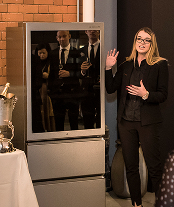 A curator is explaining about LG SIGNAUTRE Wine Cellar for the guests at the premium event held in London