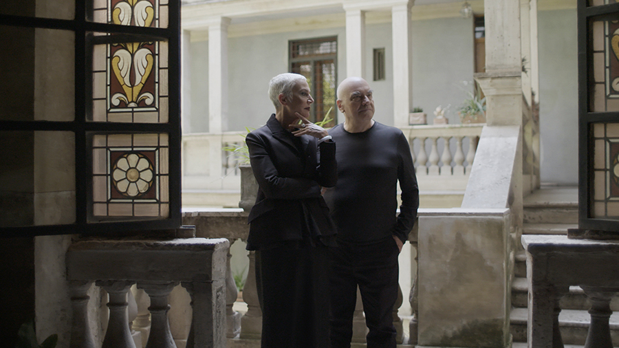 Massimiliano and Doriana Fuksas are standing and looking over something together