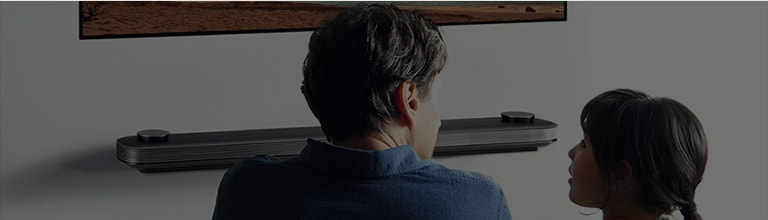 Background picture of husband, wife and child watching TV on the wall