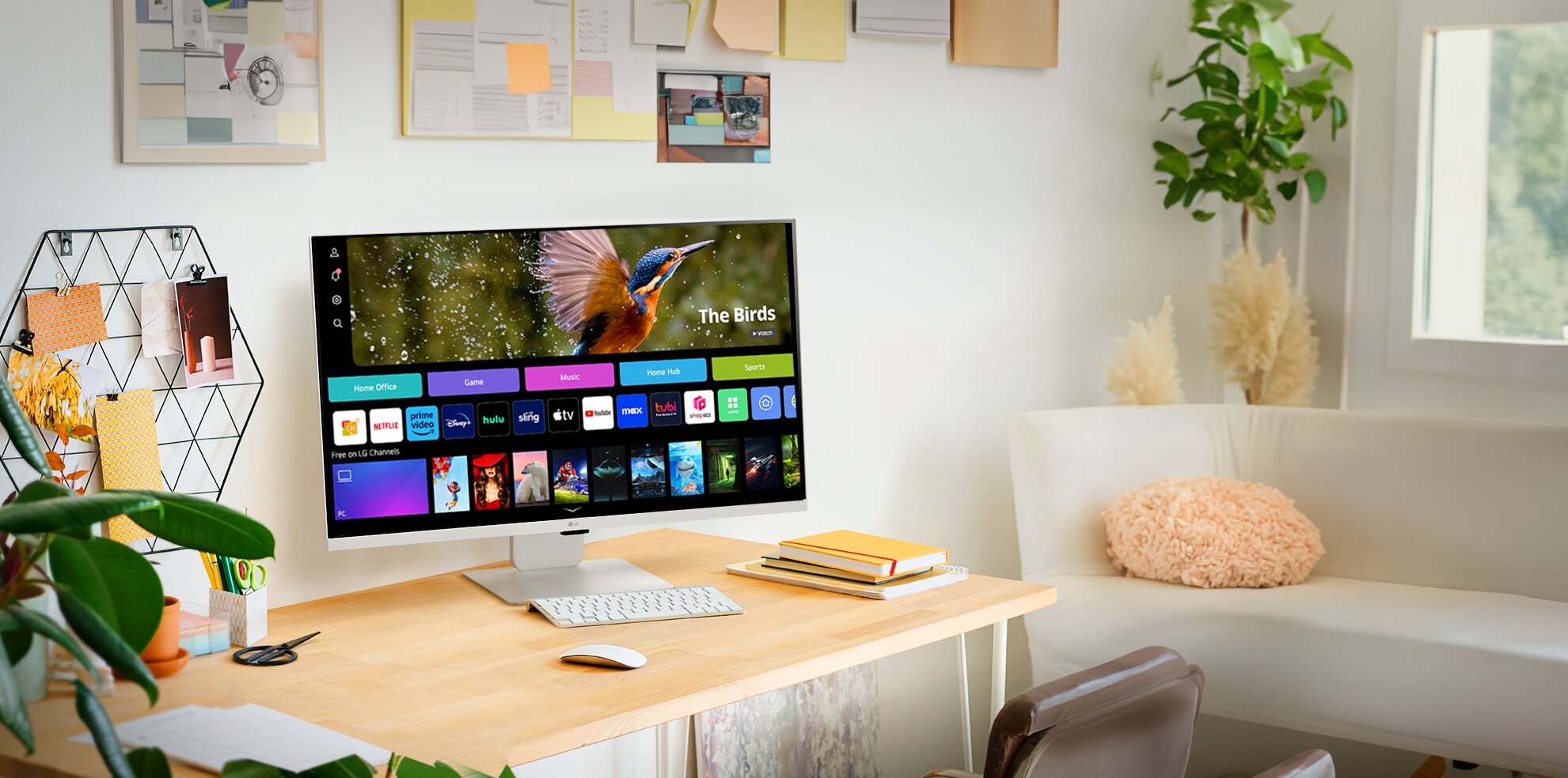 The LG MyView Smart Monitor sits on a desktop in a modern, brightly lit room and showcases its built-in webOS interface.