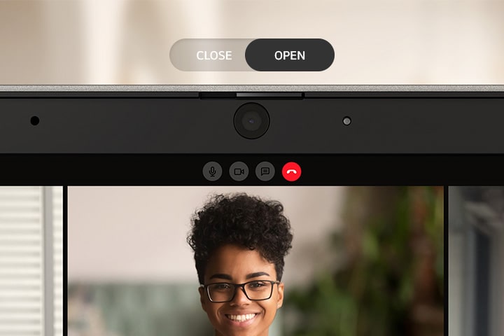 The video shows the laptop's webcam privacy feature. The "open" webcam is active with a light on, indicating it's in use while on a video call with three participants. You can close the webcam right away by sliding the shutter, and the screen will turn off immediately.