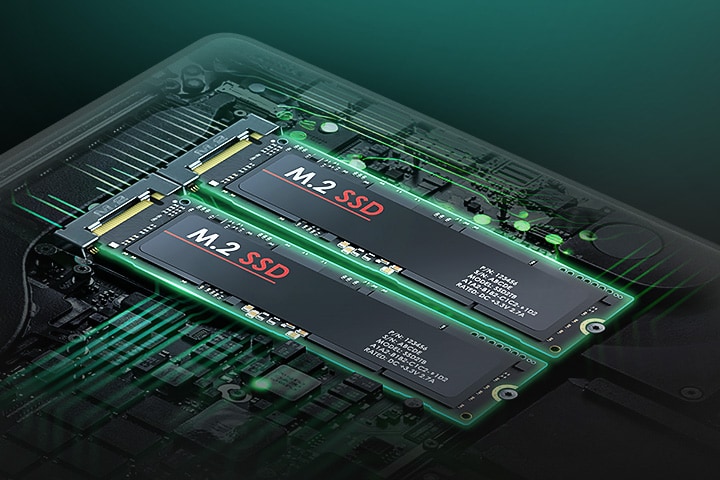 The image highlights the laptop's internal hardware, showcasing two M.2 SSDs installed side by side on the motherboard. The components are illuminated with a green glow, emphasizing the dual SSD configuration.