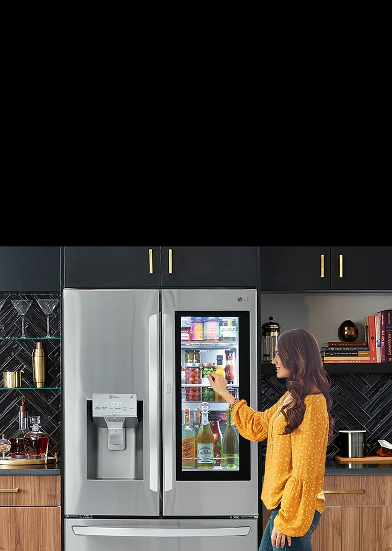 A woman knocking on the window of the LG InstaView Refrigerator