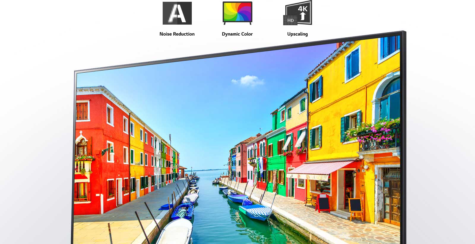 A TV screen displaying a port city where buildings are painted in multiple colors and little boats are anchored in long and narrow harbor.