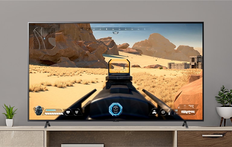 A TV screen playing a video of a FPS game shooting an enemy with a gun. (play the video)