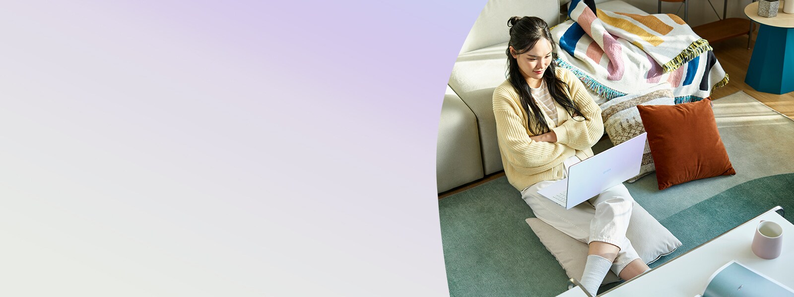 woman on a couch looking at her laptop