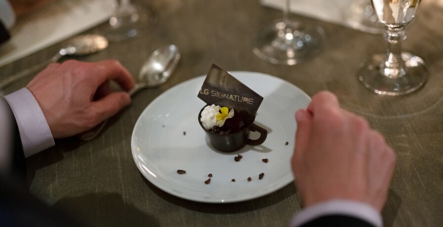 A plate of chocolate dessert sits on a dinner table at the event.