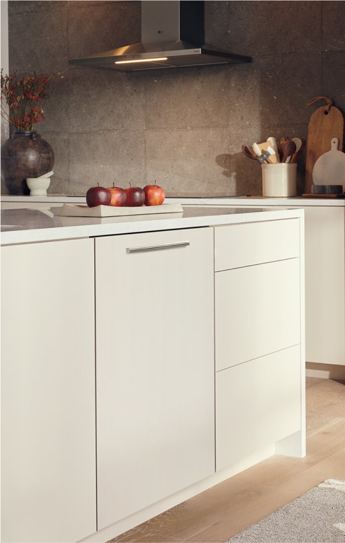 A modern kitchen with a built-in LG Studio panel-ready dishwasher, seamlessly integrated into the cabinetry.