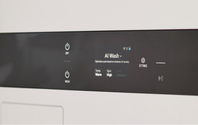 Close-up of LG Studio WashTower control panel displaying settings for AI Wash and other features.